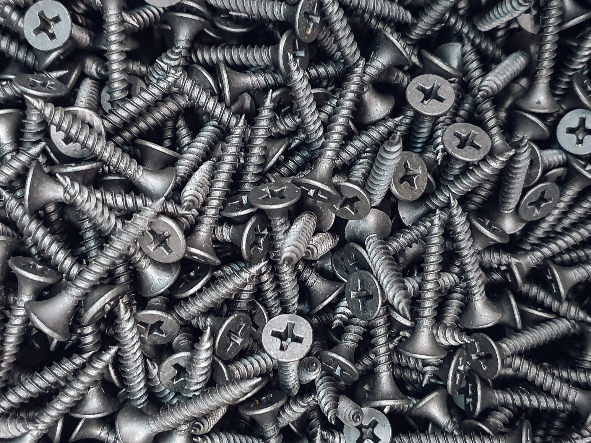 Screws. Black steel screws for background.